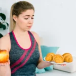 A person struggling with the physical and health disadvantages of being overweight including joint pain and fatigue