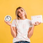 A woman managing her menstrual cycle health by avoiding unhealthy foods, stress, and harmful habits during periods